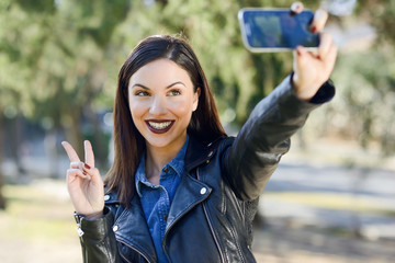 Beautiful young woman selfie in the park