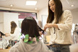 © Monet - Woman hairdresser curled the hair of women