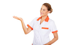 Smiling Female Doctor Or Nurse Pointing At Something