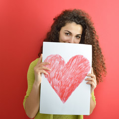 Love and valentines day woman holding card with drawing heart an