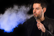 Man with e-cirarette mod blowing cloud of vapor