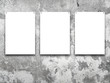© ma3d.it - Close-up of three nailed blank frames on stained concrete wall background