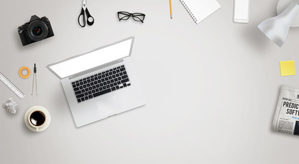 Leinwandbilder - Work desk with laptop and free space for text surrounded with a lot of desk accessories. There is a phone, camera, coffee, glasses, pens, paper, newspaper, lamp...