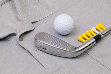 Grey polo shirt and golf equipments