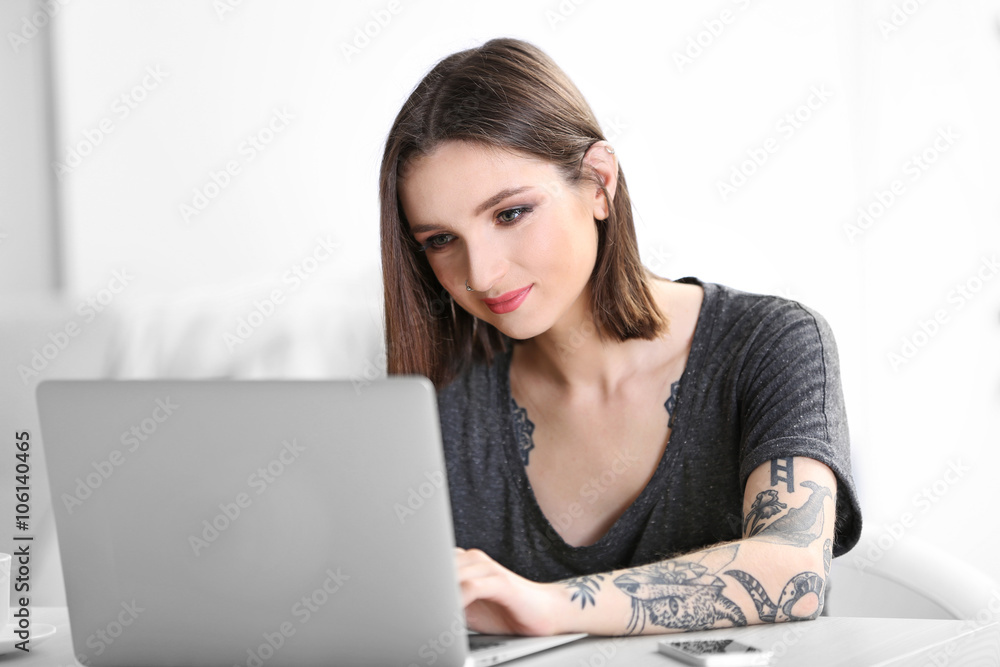 Woman sitting at the table and working with laptop