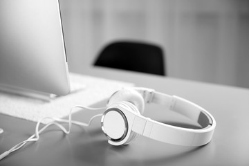 Wall Mural - Headphones on gray table against defocused background