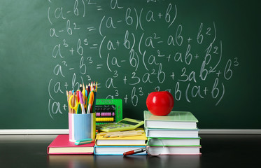 Poster - School books on desk near chalkboard