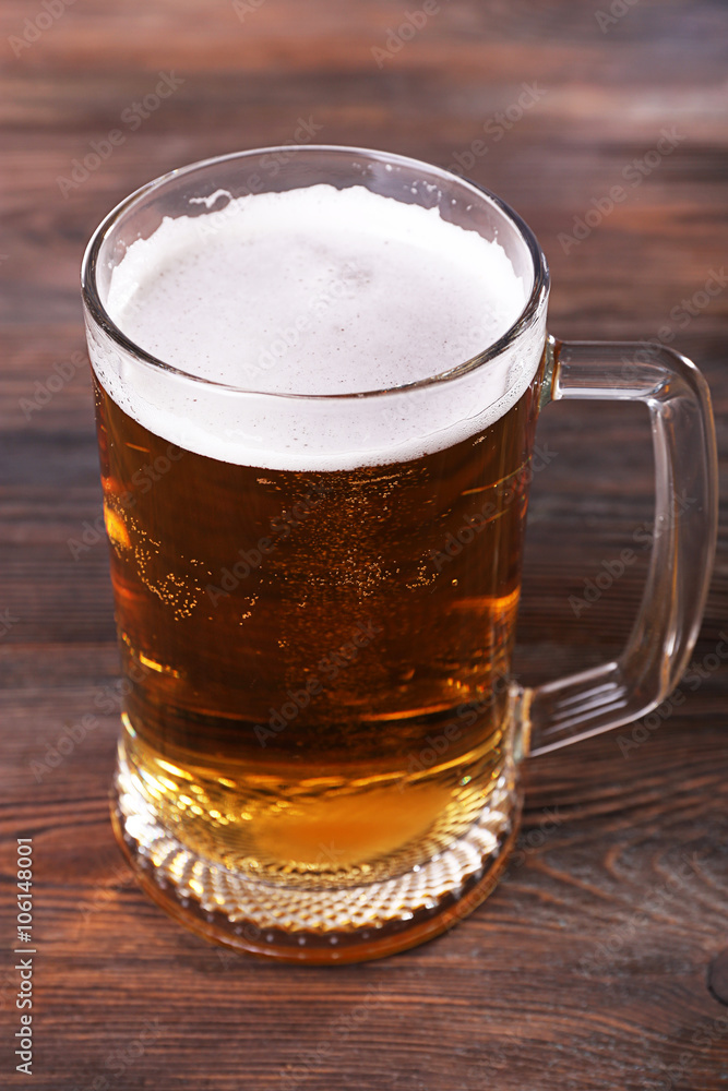 Glass of beer on wooden background