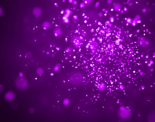 star-shaped purple glittery bokeh in front of a dark purple background