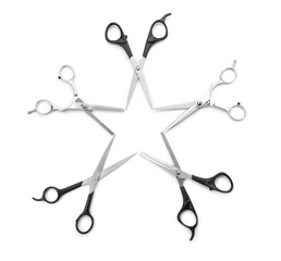 Wall Mural - A star created within blades of five  professional scissors isolated on white background