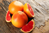 Fototapeta Kuchnia - Juicy grapefruits on wooden background