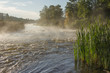 Morning summer landscape on the river with rapids and mist in Karelia on Ladoga. River Asilanyoki