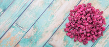 Dried Pomegranate Seeds Over Wooden Background