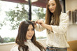 © Monet - Young women are coloring their hair at the beauty salon