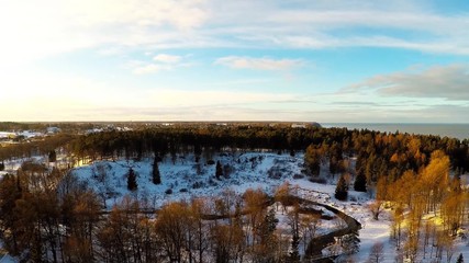 Wall Mural - Winter landscape. Aerial footage. Sunset. River and sea coast.