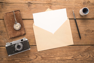 Wall Mural - Different objects and envelope on a wooden table 