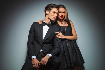 attractive elegant couple in black posing embraced
