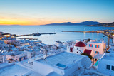 Fototapeta  - View of Mykonos town and Tinos island in the distance, Greece.