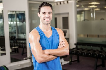 Wall Mural - Handsome man with arms crossed looking at camera