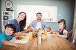 © WavebreakmediaMicro - Portrait of smiling family with food on dining table