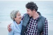 © WavebreakMediaMicro - Happy man standing with mother at sea shore