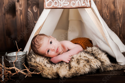 Baby Boy Photo Studio On A Wooden Background Premium Photo