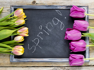 Wall Mural - Easter eggs and tulips with blackboard