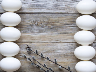 Wall Mural - Bunch of willow, white eggs and on wooden plank texture.