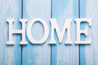 © sunwaylight13 - White letters with word HOME on wooden surface