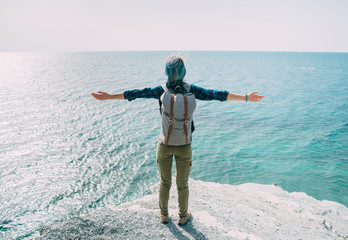 Canvas Print - Happy explorer traveler girl standing on coast