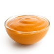 Small glass condiment bowl of  orange cocktail sauce. Isolated.