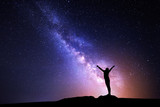 Fototapeta Kosmos - Milky Way. Night sky and silhouette of a standing girl