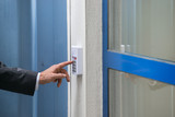Fototapeta Mapy - Close-up Of Businessman Using Door Security System On Wall