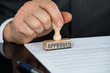 © Andrey Popov - Close-up Of Businessman Hand Stamping On Approved Contract Form