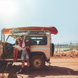 © Jacob Lund - Couple taking a break to look at map while on roadtrip