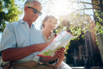 Wall Mural - Senior couple together in the city with a map