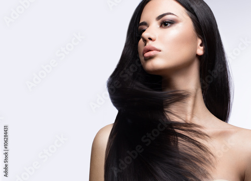 Beautiful brunette girl in move with a perfectly smooth hair, and classic make-up Wallpaper Mural