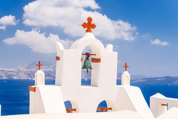 Wall Mural - Details of a church in famous Oia village and view of volcanic caldera, Santorini island, Greece