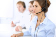 © rogerphoto - Call center. Focus on beautiful woman in headset