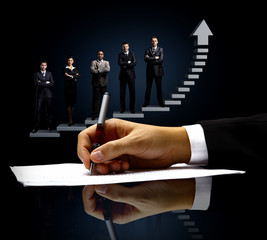 The signing of the document. on the background of business people