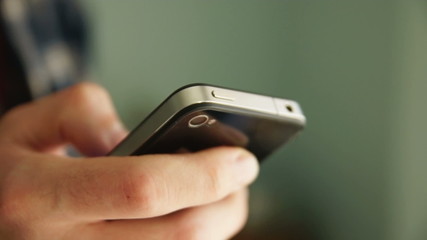 young adult man using his smartphone.