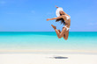 © Maridav - Happy bikini woman jumping of joy on beach. Excited holiday girl doing a jump of freedom and happiness in a free body. Weight loss success healthy lifestyle concept.