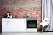 Modern Kitchen Furniture Against Brick Wall Background