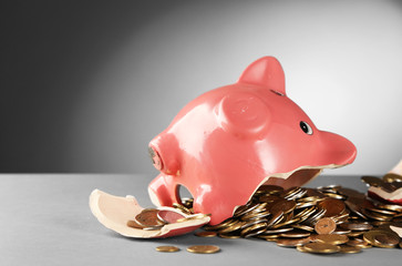 Sticker - Broken piggy bank on the table against grey background, close up