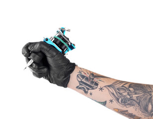 Wall Mural - Tattooist hand in black glove with tattoo machine isolated on white background, close up