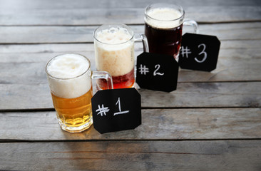 Wall Mural - Glass mugs with different sorts of craft beer and numbering on wooden table