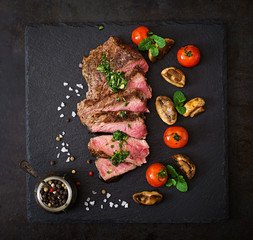 Wall Mural - Juicy steak medium rare beef with spices and grilled vegetables. Top view