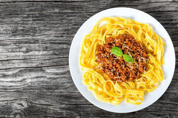 Wall Mural - Bolognese ragout with italian pasta on a white plate, close-up