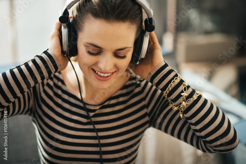 Foto Frau, die Musik in der Dachbodenwohnung hört. Porträt schließen.