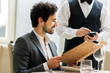 © Minerva Studio - Man with menu in a restaurant making order